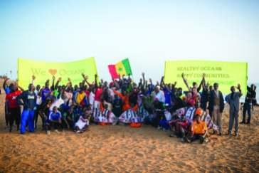 In Dakar, hundreds of oceans lovers, fishers and Greenpeace volunteers celebrate World Oceans Day. The event is held on the “Parcours Sportif", one of the most famous beaches of Senegal where people gather every afternoon for jogging and sports. The activists demonstrate how they all rely on healthy and beautiful oceans through a choreographed "flash mob" accompanied by music. Participants, some wearing fish costumes, display banners with the messages “We Love Oceans” and “Healthy Oceans, Happy Communities.” In the picture the participants pose for a group photo at the end of the activity.